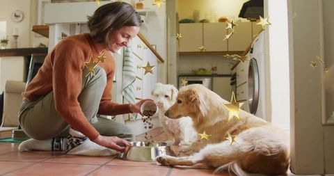 Kneeling woman pouring dry dog food into steel bowl in cozy kitchen with golden retriever