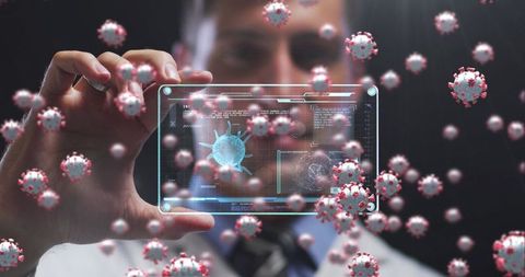 Scientist analysing covid-19 in digital interface surrounded by virus cells