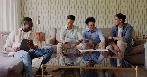 Men discussing wedding plans in modern living room