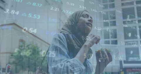 Hijab-Clad Woman with Rising Stock Market Data Overlay