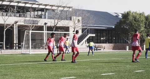 Youth Soccer Players Competing during Match on Sunny Day
