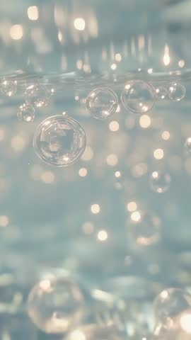 Vertical Underwater Bubbles Rising in Soft Bokeh Light for Minimalist Motion Background