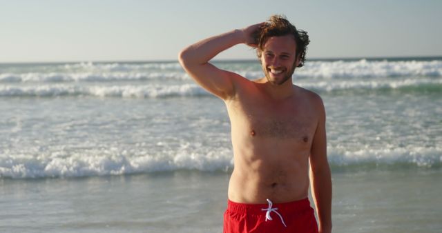 Happy Man in Red Swim Trunks Enjoying Sunny Beach Day - Download Free Stock Images Pikwizard.com