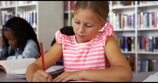 Young Schoolgirl Drawing in Busy Library Classroom - Download Free Stock Images Pikwizard.com