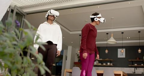 Diverse women exploring virtual reality indoors in open space