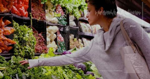 Young Woman Choosing Fresh Leafy Greens in Grocery Store