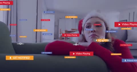 Woman with Santa Hat Sitting Amidst Digital Notifications at Home