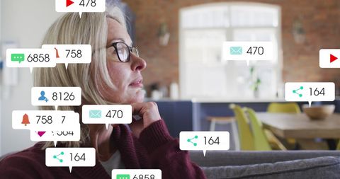 Contemplative woman engaged in social media monitoring at home