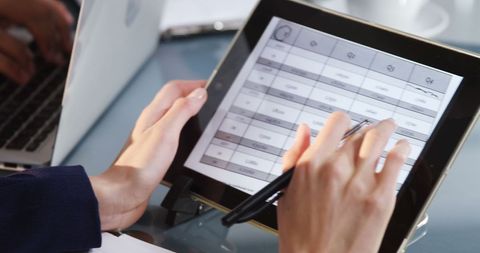 businesswoman reviewing project data on tablet at night office - Download Free Stock Images Pikwizard.com