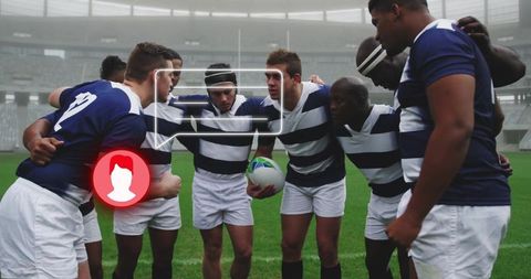 Diverse rugby team huddling in stadium for motivation