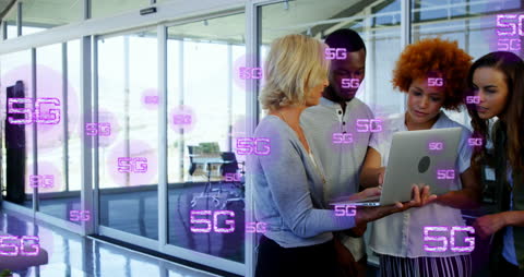 Diverse Team Collaborating on Laptop with 5G Technology Overlay