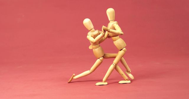 Wooden Mannequins Engaged in Warm Embrace Against Red Background - Download Free Stock Images Pikwizard.com