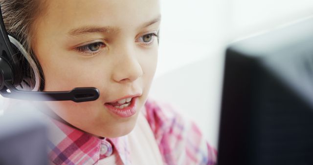 Young Child Wearing Headset Using Computer Indoors - Download Free Stock Images Pikwizard.com