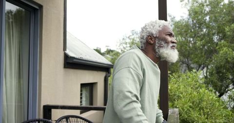 Senior man contemplating on balcony amid nature