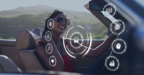 Woman driving convertible with futuristic technology icons overlay