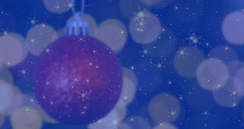 Glistening Purple Christmas Bauble on Festive Background