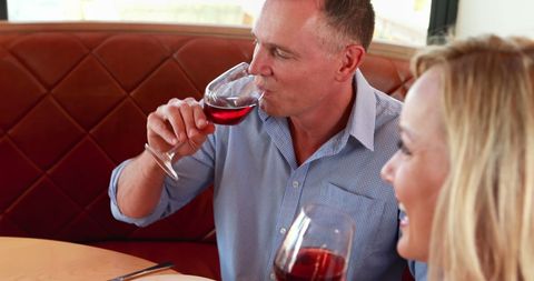 Couple Enjoying Wine at Cozy Restaurant Table - Download Free Stock Images Pikwizard.com