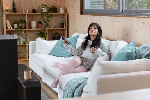 Relaxing at Home with a Hot Drink on Cozy Sofa