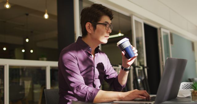 Focused Professional Working on Laptop and Drinking Coffee - Download Free Stock Images Pikwizard.com