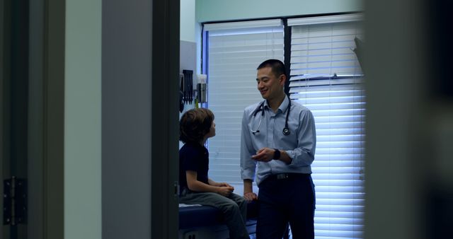 Male Doctor Interacting with Young Patient in Examination Room - Download Free Stock Images Pikwizard.com