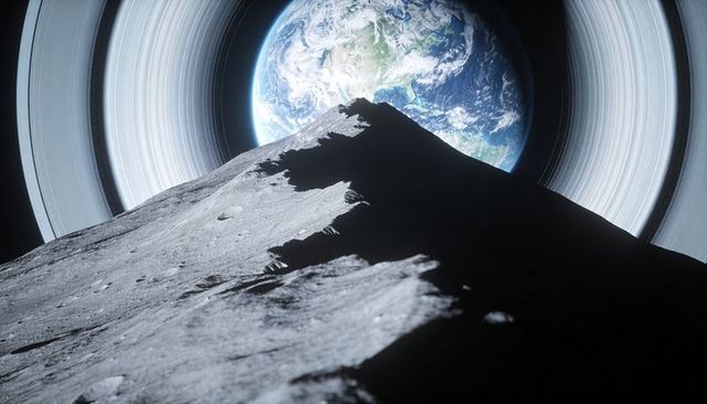 Craggy ridge rising over ringed blue planet silhouette on cratered regolith horizon
