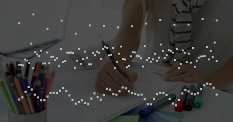 Woman Focusing on Work at Organized Desk with Charts and Stationery