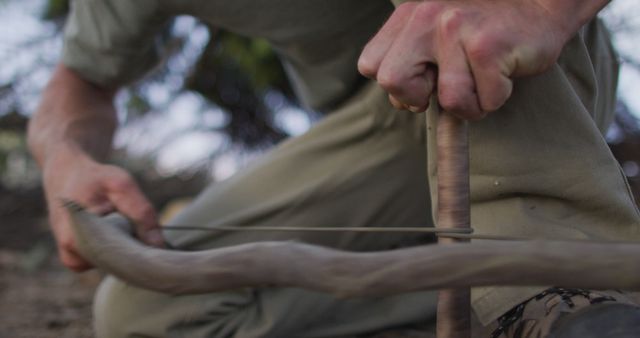 Person Using Bow Drill to Start Fire Outdoors - Download Free Stock Images Pikwizard.com