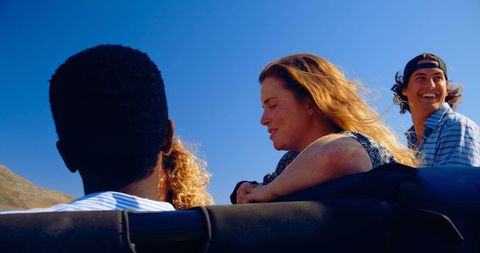Young Friends Laugh Together on Road Trip in Convertible - Download Free Stock Images Pikwizard.com