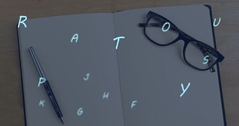 Floating Letters Over Glasses on Notebook