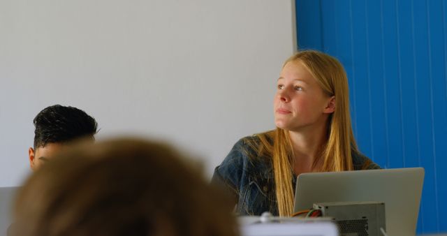 Attentive Student with Laptop in Classroom - Download Free Stock Images Pikwizard.com