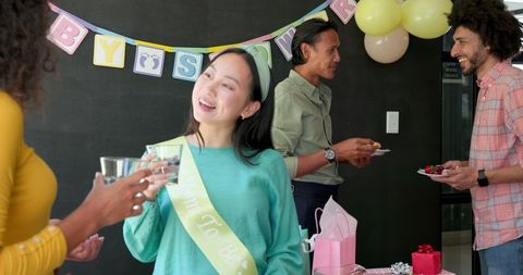 Colleagues Celebrating Joyful Baby Shower at Office Get Together