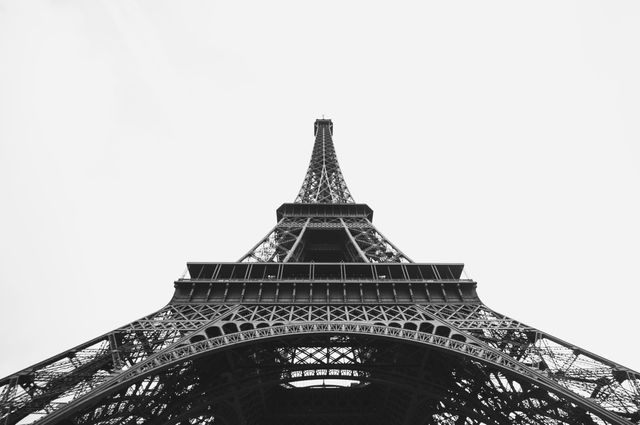 Upward View of Eiffel Tower on Cloudy Day - Download Free Stock Photos Pikwizard.com