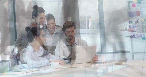 Business team reviewing project on laptop in modern glass office with blurred commuters
