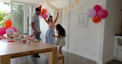 Joyful Family Birthday Celebration at Home with Balloons and Decorations