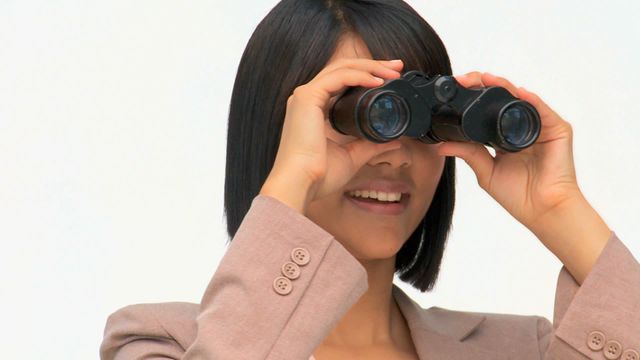 This video depicts a businesswoman using binoculars, symbolizing vision and forward-thinking strategies. Useful for presentations or reports on business planning, innovation, strategic vision, corporate foresight, and future goals.