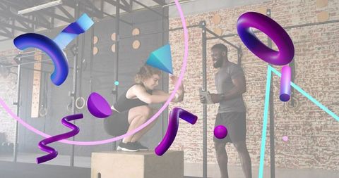 Female trainee performing box squat on plyo box with coach supervising in industrial gym