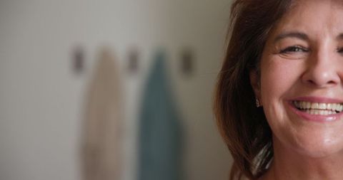 Elegantly Smiling Senior Woman in Cozy Interior