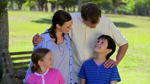 Happy Family Enjoying Day in Sunny Park