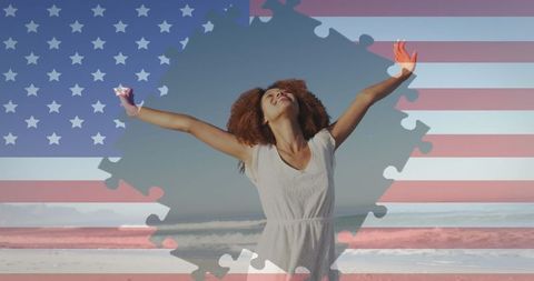 Joyful woman embracing freedom on beach against american flag