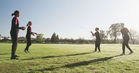 Female Athletes Practicing with Flying Disc in Morning Park