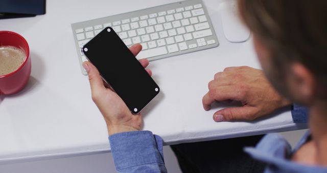 Person Working at Desk with Smartphone and Keyboard - Download Free Stock Images Pikwizard.com