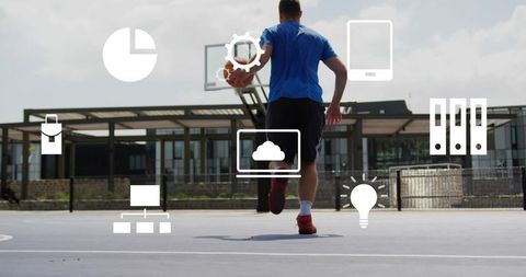 Urban basketball player dribbling toward hoop on outdoor court with digital tech icons overlay