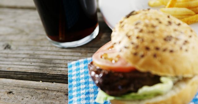 Close-Up of Classic Beef Burger with Cola Drink on Rustic Table - Download Free Stock Images Pikwizard.com