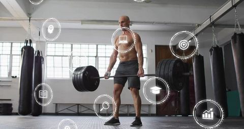 Shirtless athlete performing heavy deadlift in industrial gym with HUD fitness icons