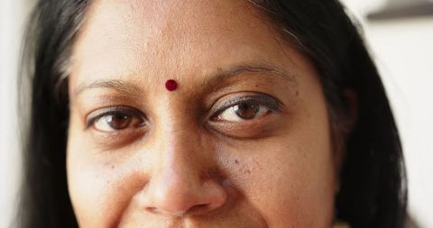 Smiling Indian Woman Wearing Traditional Bindi Close-up Portrait