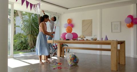Family Cleaning Confetti After Home Birthday Party Celebration