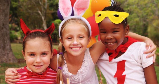 Three young girls dressed in playful costumes smile for the camera, with copy space - Download Free Stock Photos Pikwizard.com