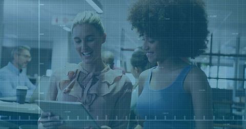 Diverse Colleagues Collaborating on Tablet in Open Office