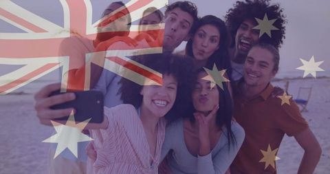 Friends capturing fun beach selfie with australian flag overlay