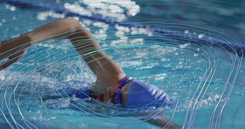 Female Swimmer Performing Front Crawl in Competitive Swimming Pool